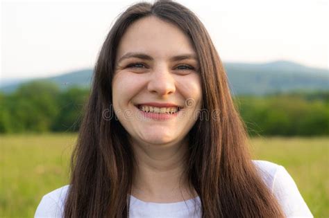 Portrait Of A 30 Year Old Brunette Woman Looking At The Camera Smiling In Nature Stock Image