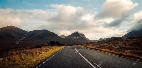 Premium Photo | Beautiful view of a highway with mountains and a cloudy sky