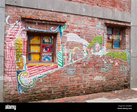 A Colorful Mural Grafitti Art On A Red Brick Wall Among The Historic