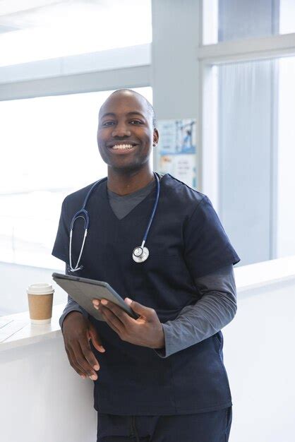 Premium Photo Portrait Of Happy African American Male Doctor Holding