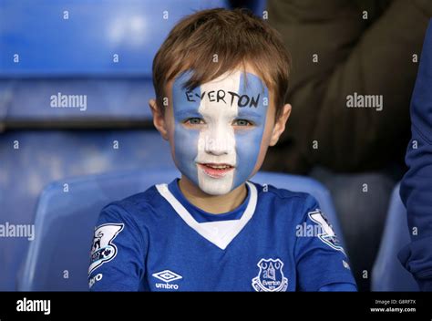 A young Everton fan wearing blue and white face paint during the ...