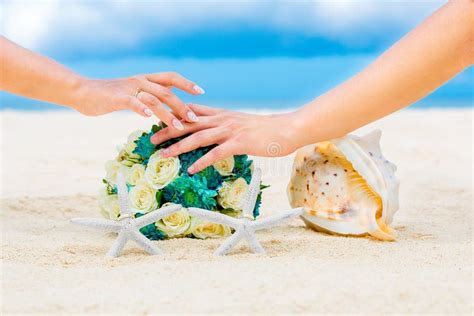 Male And Female Hands Two Wedding Rings With Two Starfish Wedding