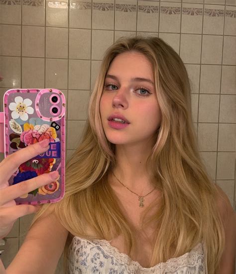 Blonde Woman Taking A Selfie In A Bathroom Mirror With A Phone SeaArt AI
