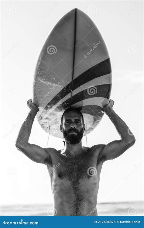 Man Surfer Carrying His Surfboard At Sunrise Hipster Male In