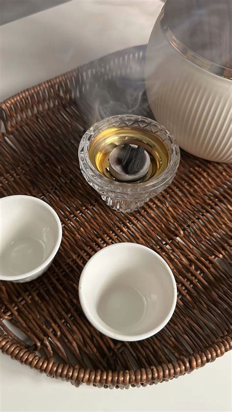 Three White Bowls Sitting On Top Of A Wicker Tray Next To A Tea Pot