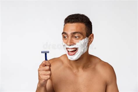 Close Up Of A Happy Naked African Man With Face In Shaving Foam Holding