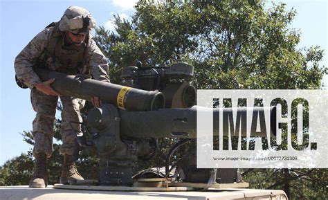 An Anti Tank Guided Missileman Loads A Tow Missile Into The M A Saber