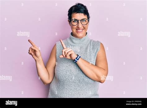Plus Size Brunette Woman Wearing Casual Clothes And Glasses Smiling And Looking At The Camera