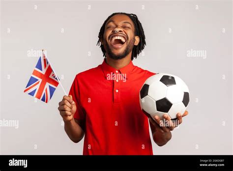 Extremely Happy Man With British Flag And Black And White Ball Wearing