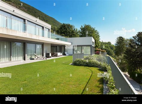 Architecture, modern white house with garden, outdoors Stock Photo - Alamy