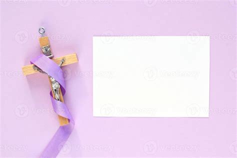 Christian religious wooden cross crucifix with violet ribbon on purple ...