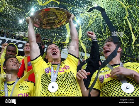 DORTMUND, GERMANY - MAY 05: Robert Lewandowski (C) of Dortmund lifts ...