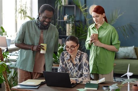 Premium Photo Diverse Business Team Using Laptop In Green Office