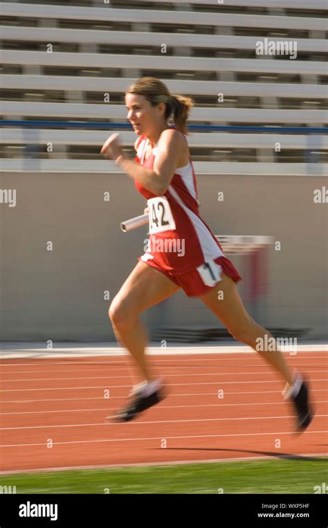 Female track athlete sprinting Stock Photo - Alamy