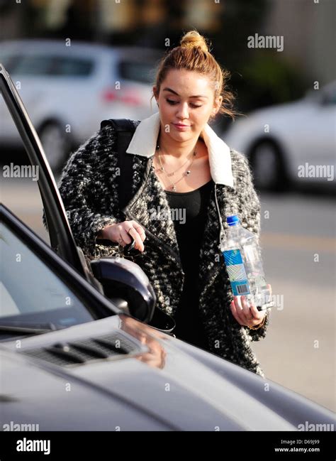 Miley Cyrus carrying a bottle of Fiji Water as she leaves California ...