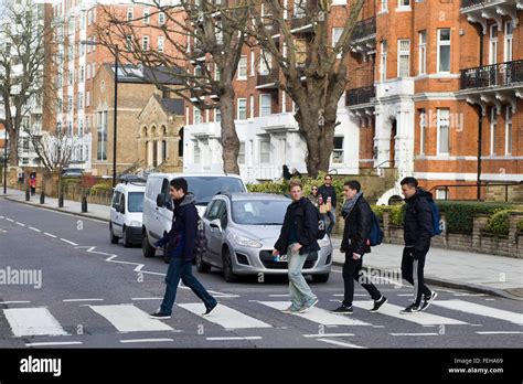 Tourists crossing the Famous Abbey Road Zebra Crossing on Abbey Road ...