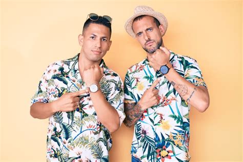 Joven Gay Pareja De Dos Hombres Con Sombrero De Verano Y Camisa Hawaiana En Apuro Apuntando A