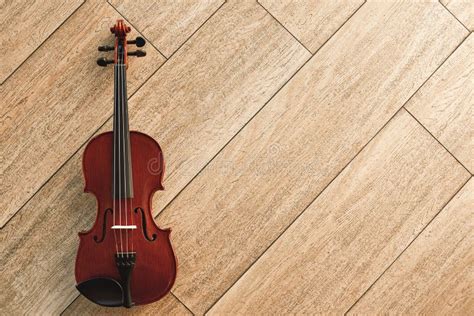 Classic Musical Instrument Top View Of The Brown Violin On The Wooden