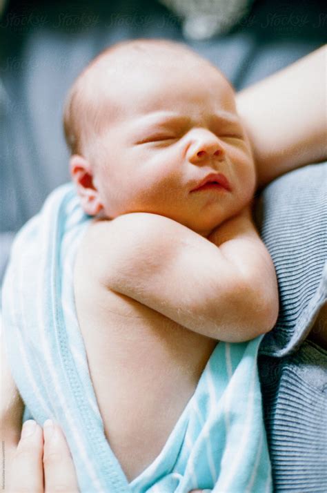 Close Up Of A Newborn In His Mother S Arms Del Colaborador De Stocksy