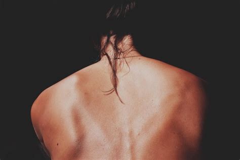 Premium Photo Rear View Of Naked Woman Against Black Background