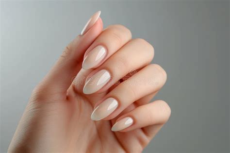 Female Hand With Elegant Colors Manicure On Neutral Background Beautiful Nude Manicure On Long
