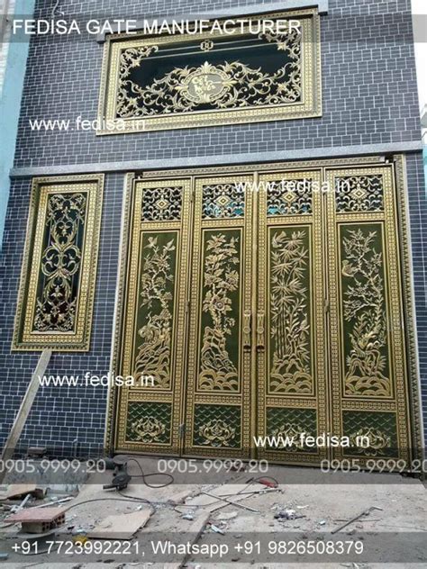 An Ornate Gold Door On The Side Of A Blue Brick Building In India With