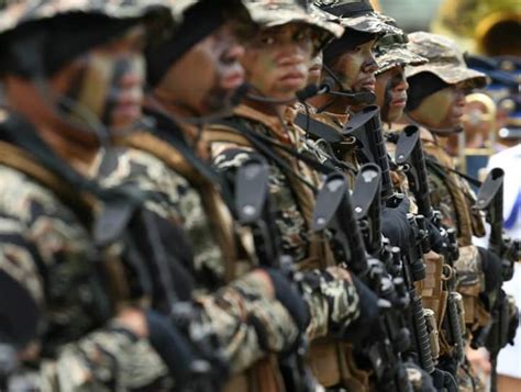 A Philippine Navy SEAL looks at the camera while they do a pass-in ...