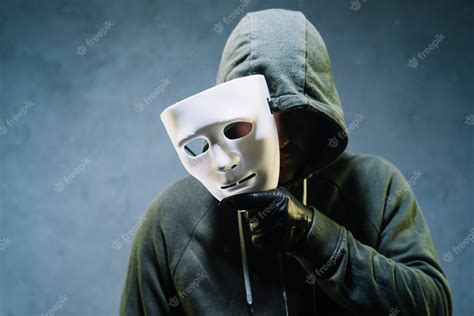 Premium Photo | Hacker holding mask