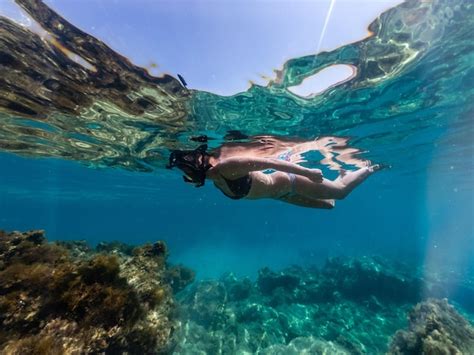 Premium Photo | Woman snorkeling around coral reef underwater photo