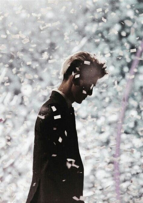 A Man Standing In Front Of Confetti Falling From The Sky With His Eyes