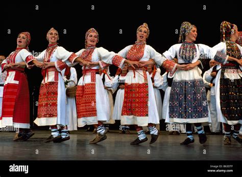 A Croatian Folk Dance Group Performing On Stage In Traditional Costume