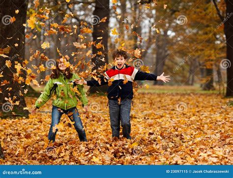 Kids Playing In Autumn Park Royalty Free Stock Photo - Image: 23097115