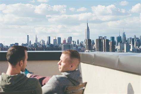 Gay Men Friends Hanging Out On A Rooftop Enjoying The View In New York By Stocksy Contributor