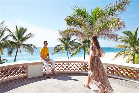 Couple On Deck At Luxury Beach Resort In Mexico By Stocksy