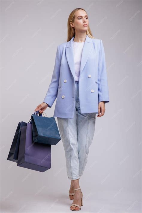 Premium Photo Elegant Woman In Pretty Blue Denim Jeans Jacket On White Background Shopping Bags