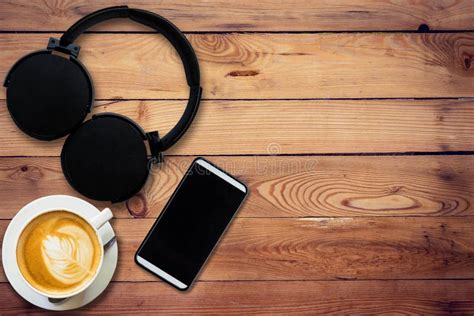 Headphone Coffee And Phone On Wood Background And Texture Stock Image