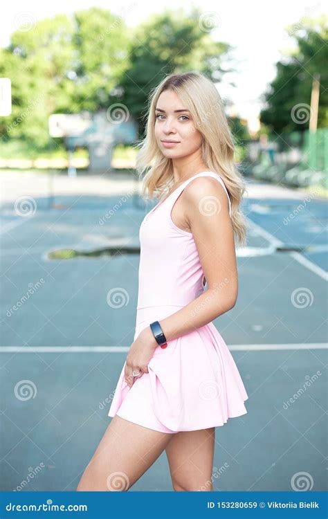Close-up Shot of Fit Young Woman Standing Outdoors in the Park ... 