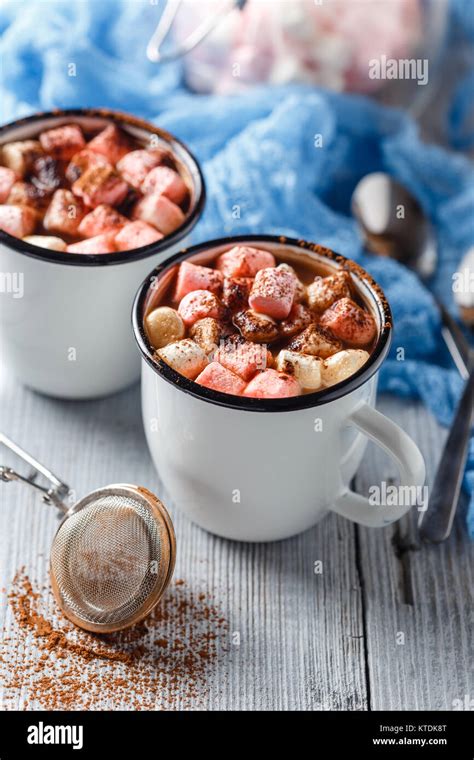 Hot Cocoa In Two Enameled White Mugs With Marshmallow On A Light Wooden Table Stock Photo Alamy