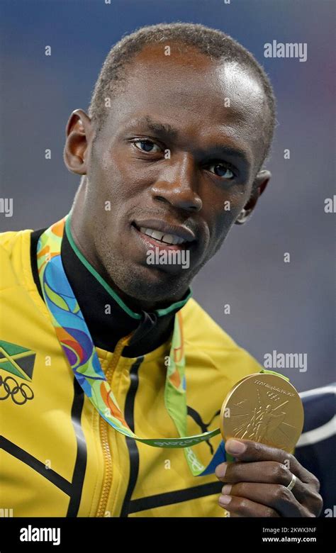 Usain Bolt Of Jamaica Pose With Gold Medal After The Mens 200 Metres