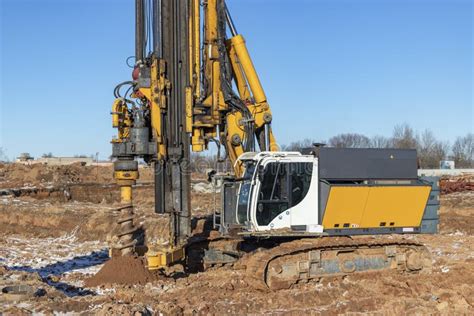 A Powerful Drilling Rig With An Auger Drills A Well At A Construction