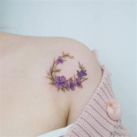 Watercolor style violet flower moon tattoo located on