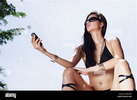 Woman In Bikini Holding Mobile Phone Stock Photo Alamy