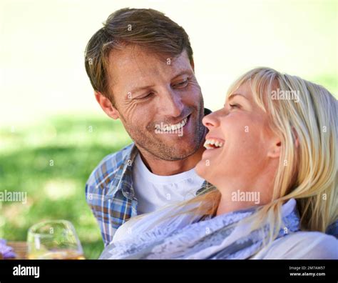 Enjoying A Romantic Day Outdoors An Affectionate Couple Enjoying A