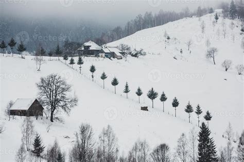 An abundant snowfall in the Romanian Carpathians in the village of ...