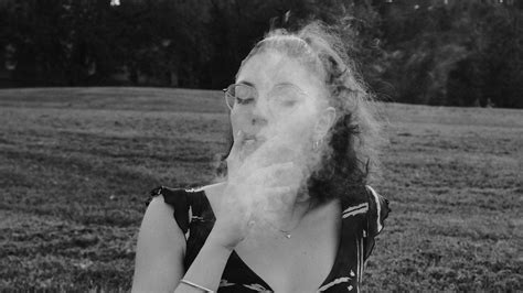 Black and White Photo of a Woman in Smoking a Cigarette · Free Stock Photo