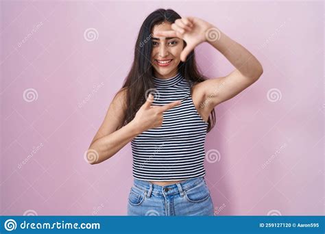 Young Teenager Girl Wearing Casual Striped T Shirt Smiling Making Frame