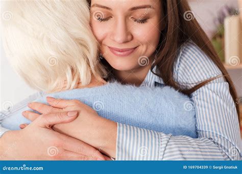 Adult Daughter Hugging Her Mature Mother At Home Stock Image Image Of