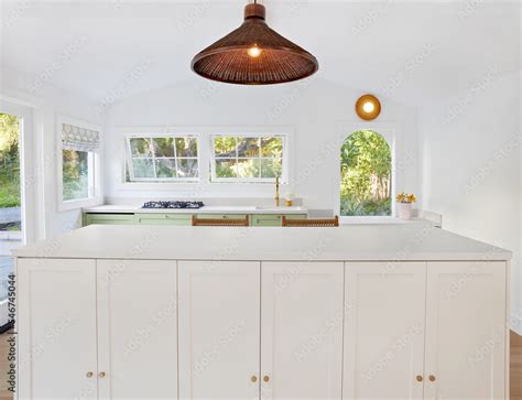 Modern kitchen and kitchen island in small cottage home Stock Photo ...