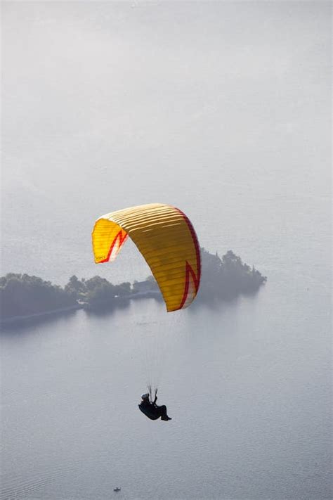 Unrecognizable person flying paraglider · Free Stock Photo