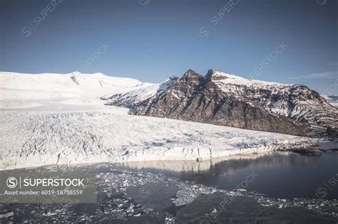 lake and glacier moraine from aerial view - SuperStock